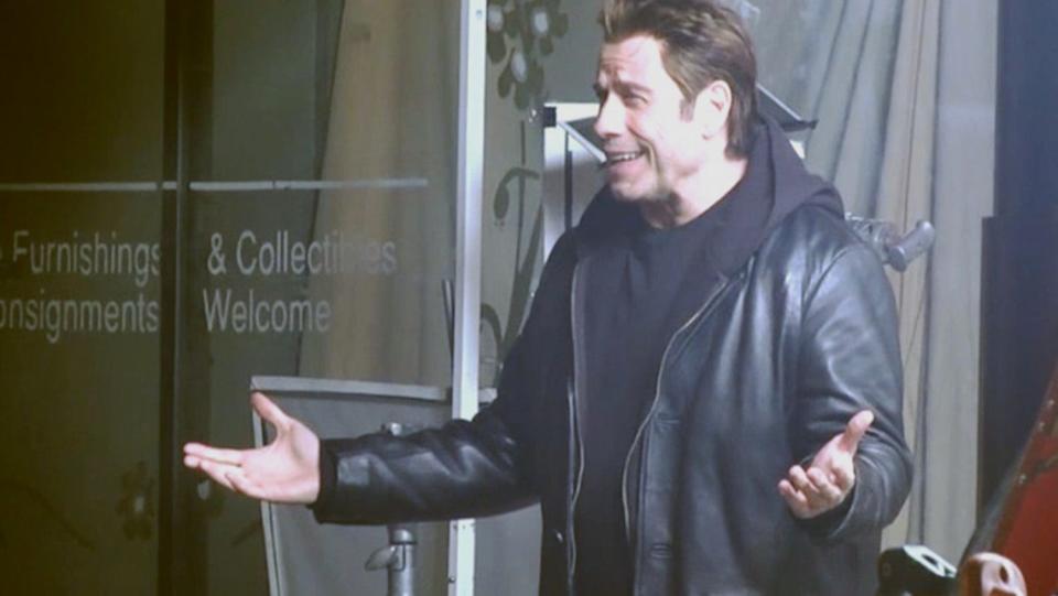 Actor John Travolta talks with fans outside the Old Familiar Barber Shop on Parsons Avenue during the filming of "I Am Wrath." The film also stars Christopher Meloni.