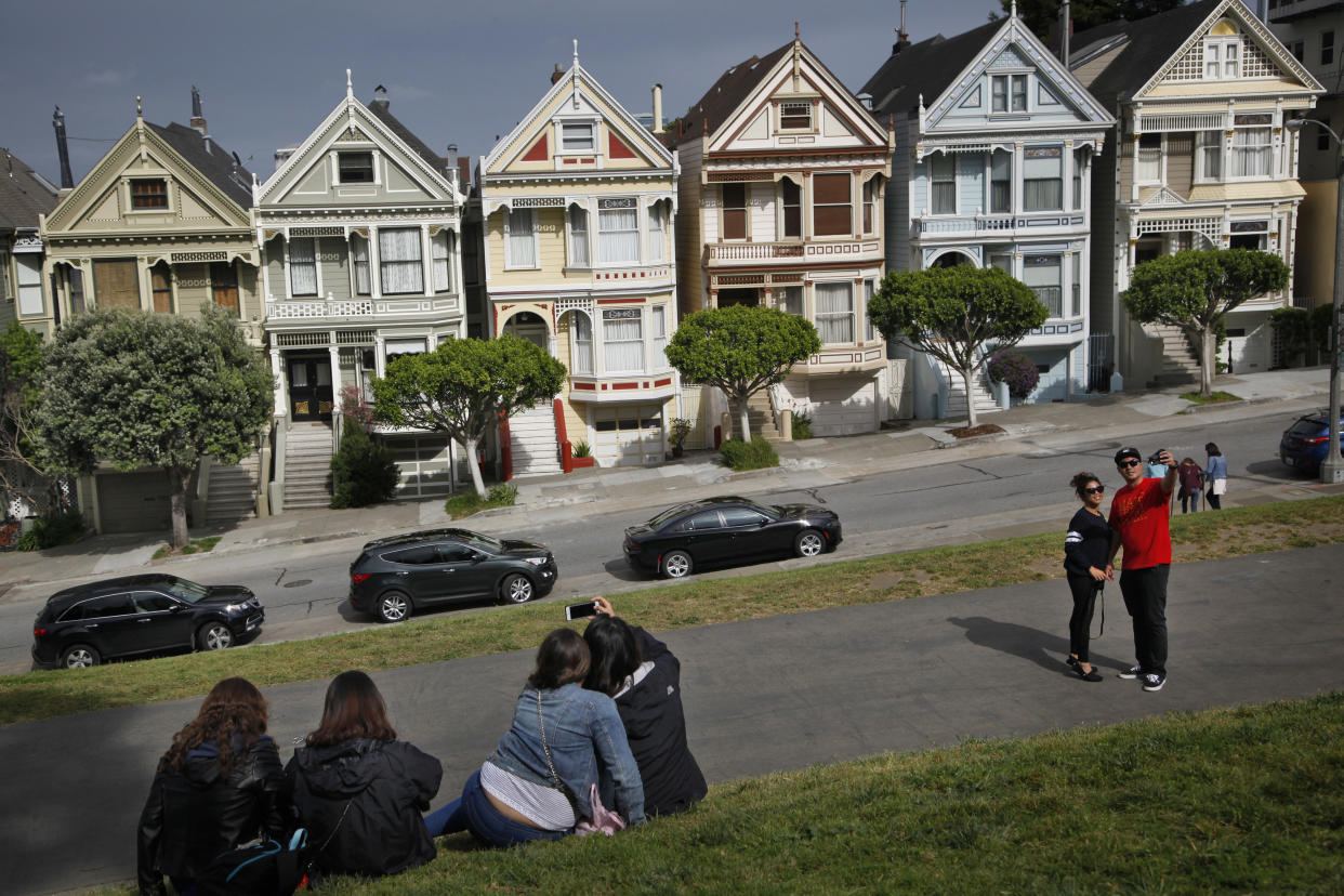 SAN FRANCISCO, CA - APRIL 8:
Tourists take pictures near the famous 'Painted Ladies' in the Alamo Square neighborhood of San Francisco, Calif., on Friday, April 8, 2015. In many parts of San Francisco, housing prices have doubled since the recession, while the city of Stockton is still recovering. 
(Photo by Preston Gannaway/GRAIN For The Washington Post via Getty Images)