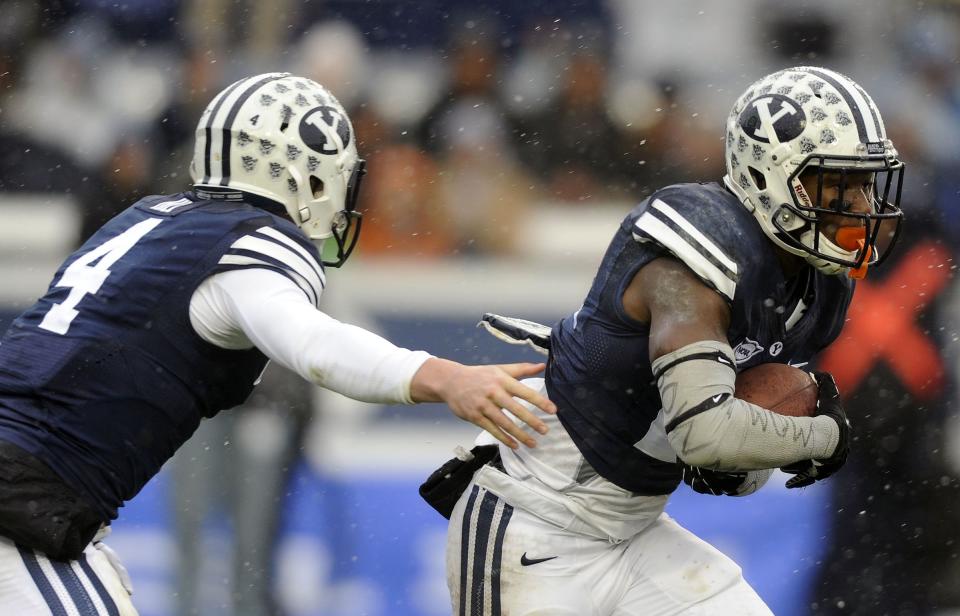 BYU quarterback Taysom Hill hands off to running back Jamaal Williams during a game at LaVell Edwards Stadium on Saturday, November 16, 2013. The former college teammates are teaming up again, this time in New Orleans. | Matt Gade, Deseret News