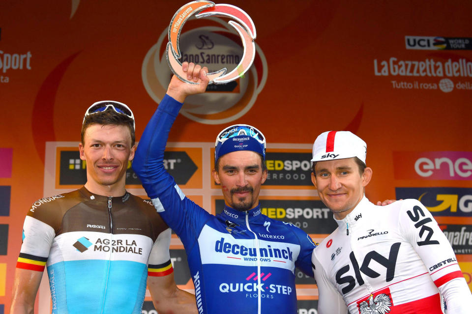 French rider Julian Alaphilippe, center, celebrates his victory on podium with runnerup Oliver Naesen, left, and third placed Michal Kwiatkowski after the 291-kilometer (181-mile) route along the Italian Riviera for the 110th edition of the Milano-Sanremo cycling classic, in Sanremo, Italy, Saturday, March 23, 2019. (Dario Belinghieri/ANSA via AP)