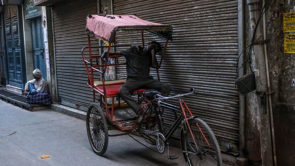 A man rests on a cycle rickshaw during a heat wave in New Delhi on April 21, 2024. - Noemi Cassanelli/CNN