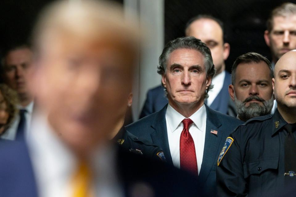 Governor Doug Burgum of North Dakota listens as former US President Donald Trump speaks to reporters at the end of the day’s proceedings in his criminal trial for allegedly covering up hush money payments at Manhattan Criminal Court on May 14, 2024 (Getty Images)