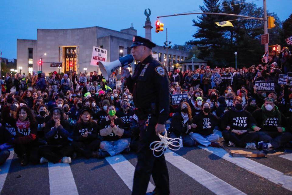 Protesters block the street near the home of Sen Chuck Schumer (AFP via Getty Images)