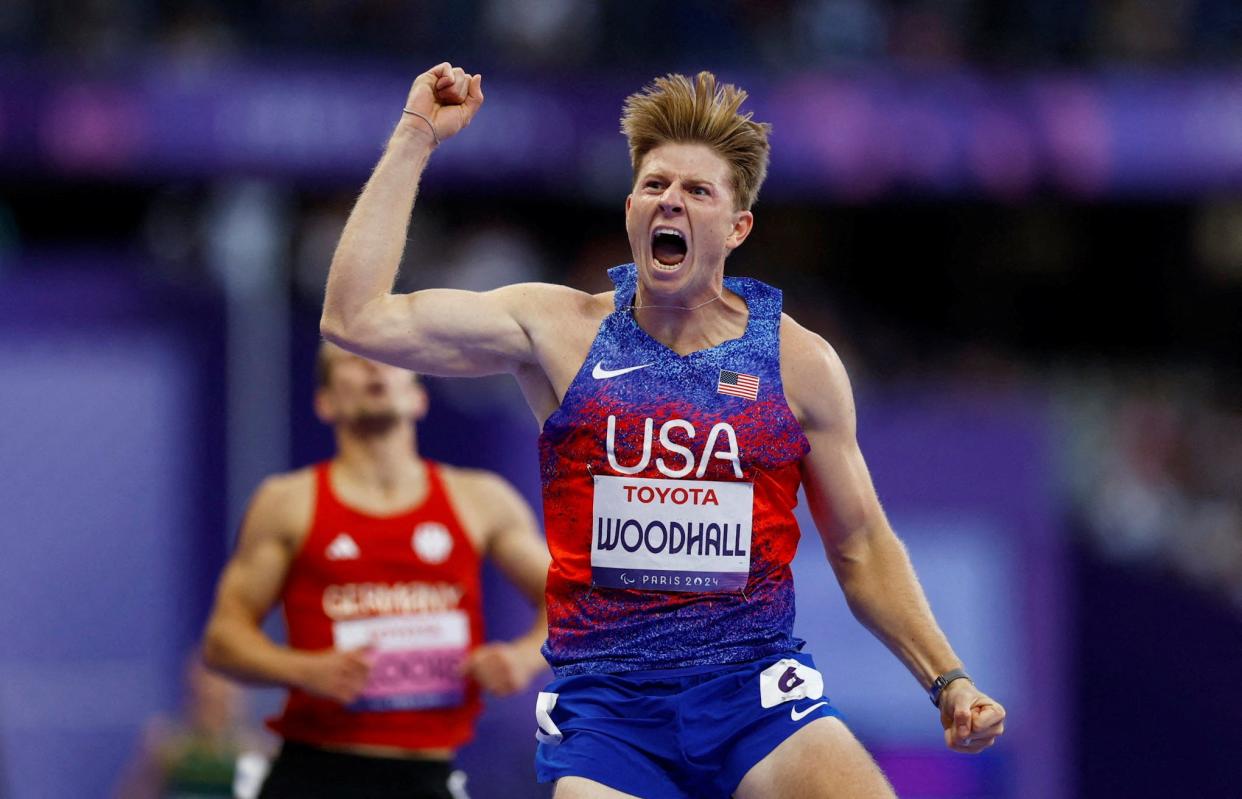 Hunter Woodhall of United States celebrates winning gold at the Paralympics.