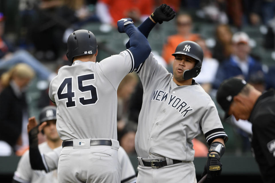 New York Yankees' Luke Voit (45) celebrates his three-run home run with Gary Sanchez, right, during the ninth inning of the team's baseball game against the Baltimore Orioles, Thursday, April 4, 2019, in Baltimore. The Yankees won 8-4. (AP Photo/Nick Wass)