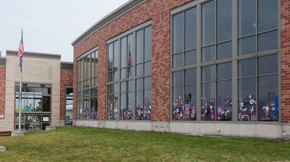 Patriotic Fourth of July paintings cover windows at the Manitowoc Public Library, Wednesday June 28, 2023, in Manitowoc, Wis.