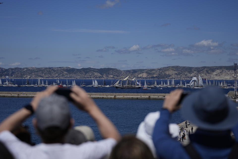 The Belem, the three-masted sailing ship which is carrying the Olympic flame, is accompanied by other boats approaching Marseille, southern France, Wednesday, May 8, 2024. After leaving Marseille, a vast relay route is undertaken before the torch odyssey ends on July 27 in Paris. The Paris 2024 Olympic Games will run from July 26 to Aug.11, 2024. (AP Photo/Thibault Camus)