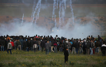 FILE PHOTO: Tear gas canisters are fired by Israeli troops toward Palestinians during a protest at the Israel-Gaza border fence, in the southern Gaza Strip February 22, 2019. REUTERS/Ibraheem Abu Mustafa/File Photo