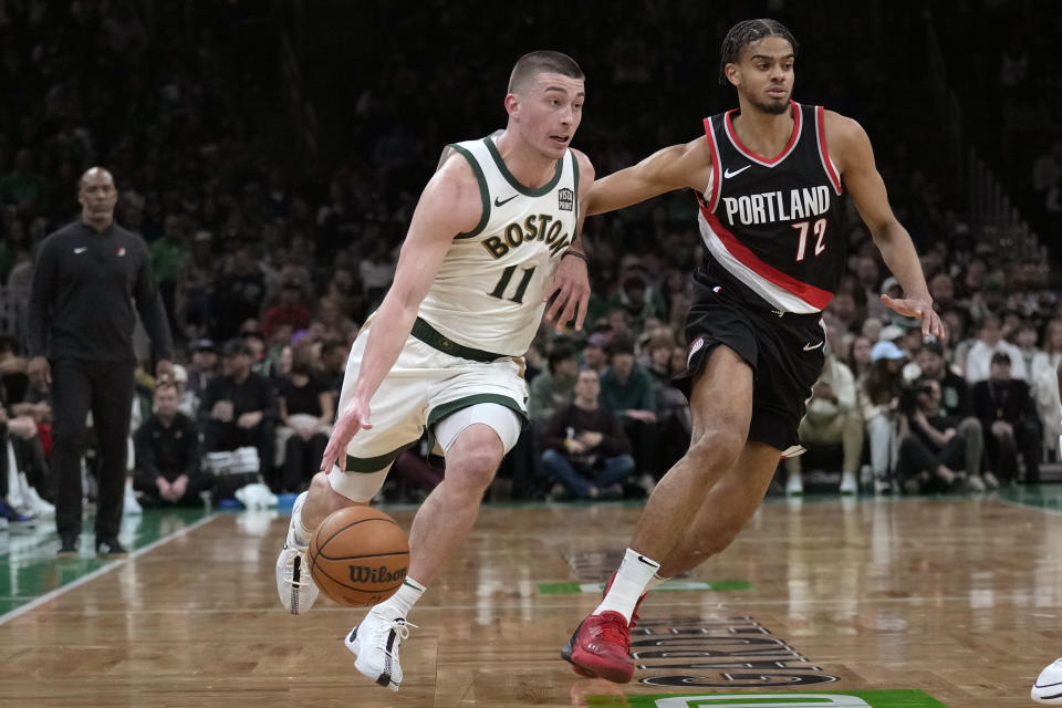 Boston Celtics guard Payton Pritchard (11) drives to the basket against Portland Trail Blazers guard Rayan Rupert (72) during the first half of an NBA basketball game, Sunday, April 7, 2024, in Boston. (AP Photo/Charles Krupa)