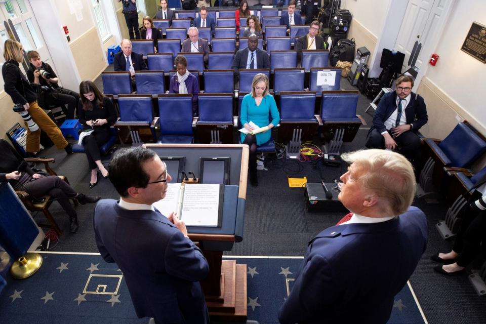 Treasury Secretary Steven Mnuchin  and President Donald Trump take part in the daily coronavirus briefing Wednesday at the White House. 