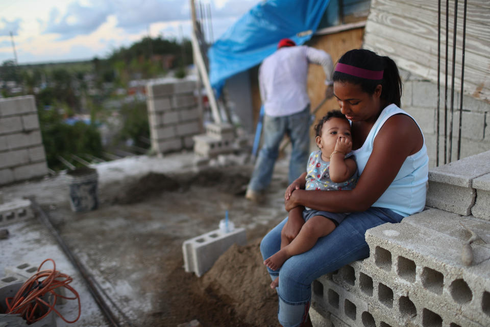 A young woman with her 9-month-old baby after their home in Puerto Rico was destroyed by Hurricane Maria, which scientists say climate change exacerbated. (Mario Tama via Getty Images)