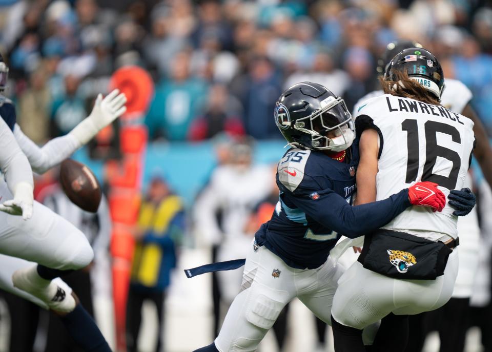 Tennessee Titans safety K'Von Wallace pressures Jacksonville Jaguars quarterback Trevor Lawrence into a bad throw in the first quarter of their game at Nissan Stadium in Nashville, Tenn., on Jan. 7.