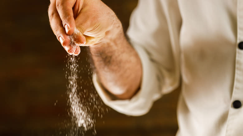 Person seasoning with salt