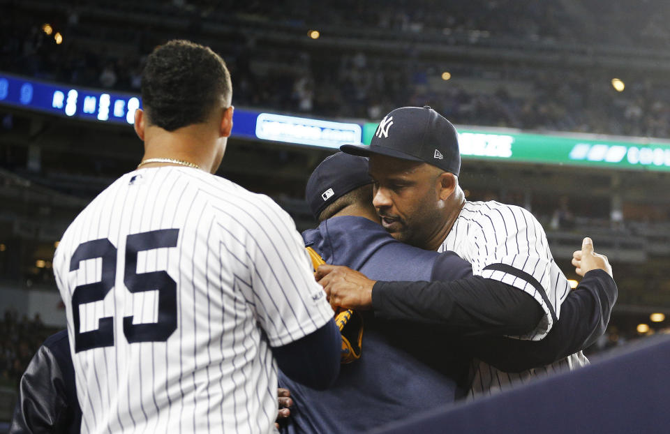 Sep 18, 2019; Bronx, NY, USA; New York Yankees starting pitcher CC Sabathia (52) is hugged by a teammate after being taken out of the game against the Los Angeles Angels during the third inning at Yankee Stadium. Mandatory Credit: Andy Marlin-USA TODAY Sports