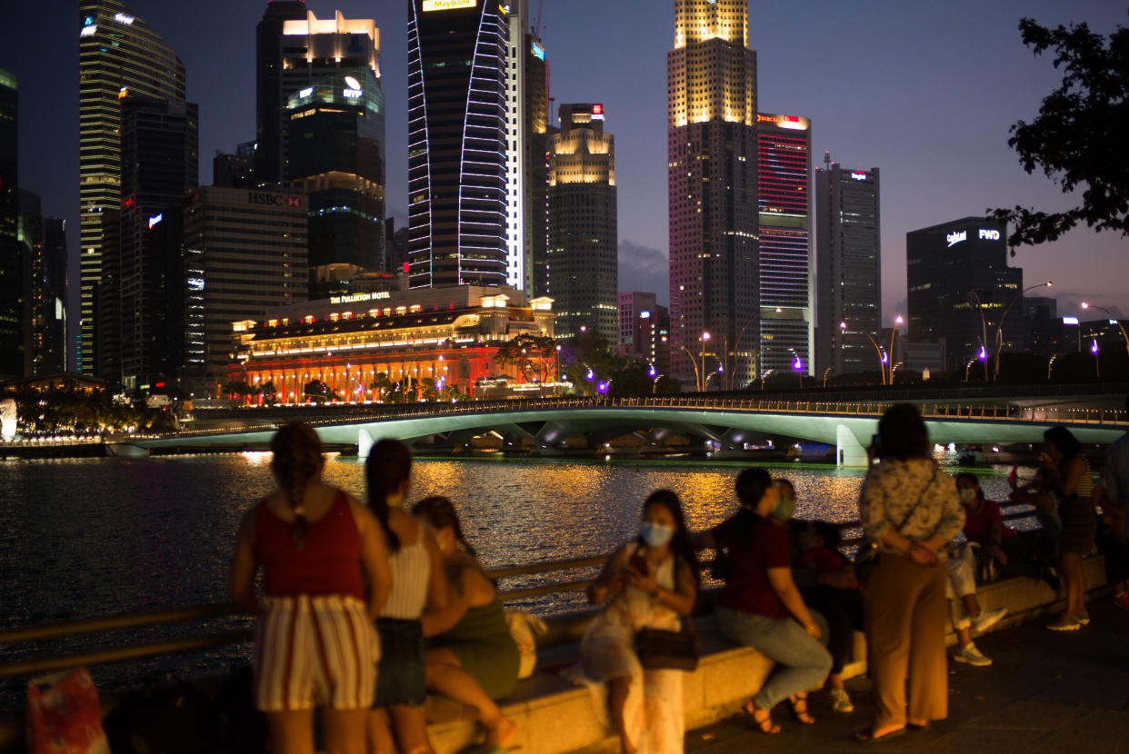 People wearing face masks along the Singapore River (PHOTO: Maverick Asio/SOPA Images/LightRocket via Getty Images)