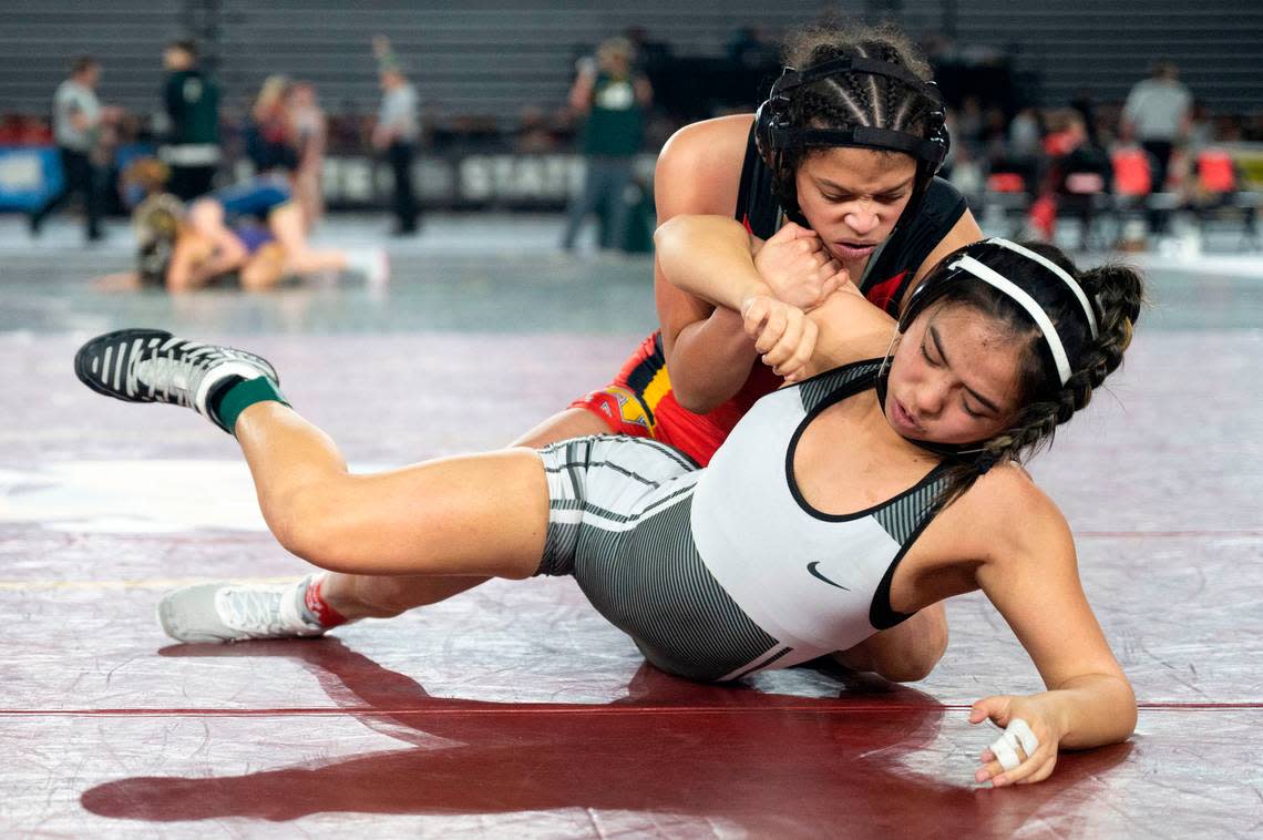 Mount Tahoma’s Zeta Lee takes down Davis’ Gracie Pham during their semifinal match in the Girls 3A/4A division at Mat Classic XXXIV on Saturday, Feb. 18, 2023, at the Tacoma Dome in Tacoma, Wash. Lee pinned Pham in three minutes, 40 seconds.