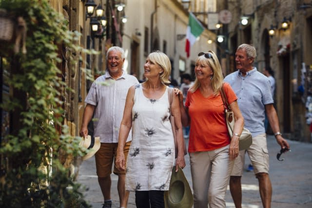 Mature Couples Looking Around Old Town Italy