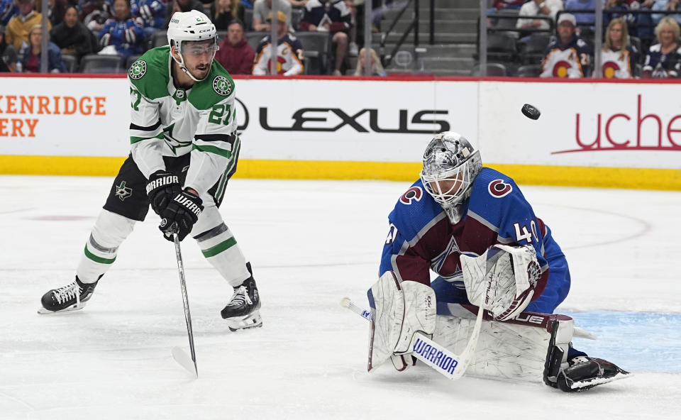 Colorado Avalanche goaltender Alexandar Georgiev, right, deflects a shot by Dallas Stars left wing Mason Marchment during the first overtime of Game 6 of an NHL hockey playoff series Friday, May 17, 2024, in Denver. (AP Photo/David Zalubowski)