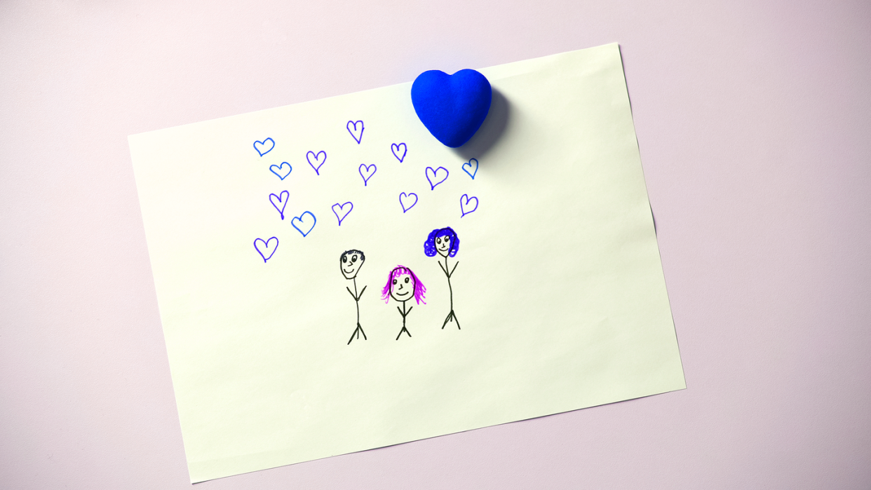 a piece of paper with a drawing of a family of three on it