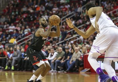 Mar 17, 2019; Houston, TX, USA; Houston Rockets guard Chris Paul (3) shoots the ball as Minnesota Timberwolves center Karl-Anthony Towns (32) defends during the third quarter at Toyota Center. Mandatory Credit: Troy Taormina-USA TODAY Sports