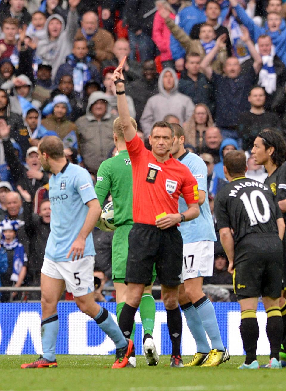 Manchester City's Pablo Zabaleta (left) is sent off by referee Andre Marriner, for a second bookeable offence, following a challenge on Wigan Athletic's Callum McManaman