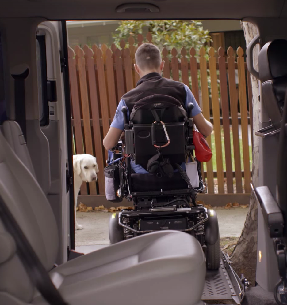 Photo of Michael Forbes exiting his van while his dog Fizz keeps a close watch on him in Melbourne.