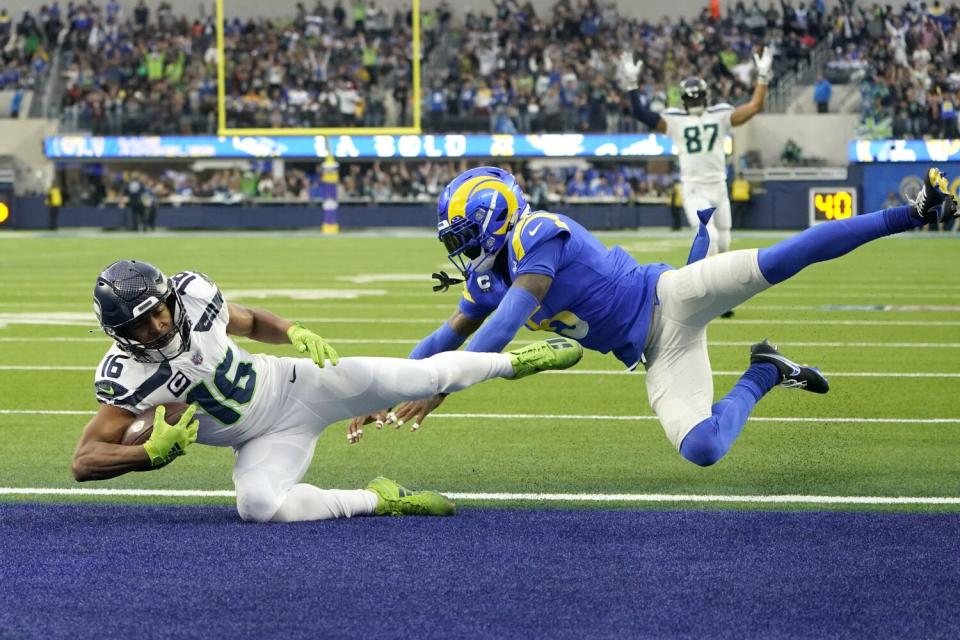 Seattle Seahawks wide receiver Tyler Lockett scores a touchdown in front of Rams cornerback Jalen Ramsey.