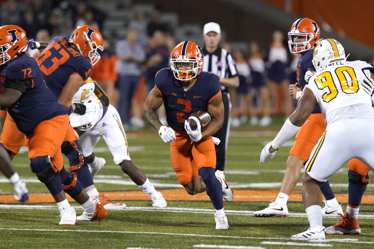 Illinois running back Chase Brown breaks into the open during the first half of the team's NCAA college football game against Chattanooga on Thursday, Sept. 22, 2022, in Champaign, Ill. (AP Photo/Charles Rex Arbogast)