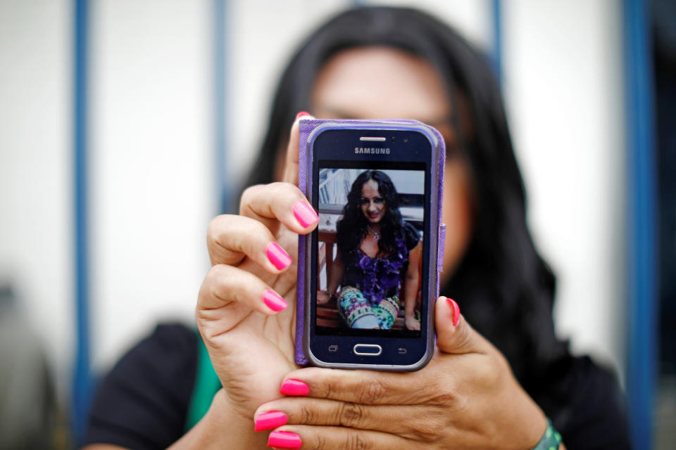 A friend in El Salvador shows a picture of Camila Diaz Cordova, a trans woman killed in that country where she returned after being denied asylum in the U.S. (Photo: Jose Cabezas / Reuters)