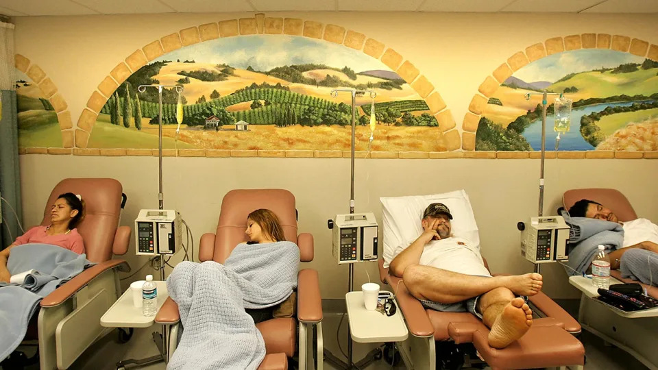 FILE -- Emily Arellano, second from left, has Valley fever and underwent treatment three days a week at San Joaquin Valley Pulmonary back in 2005. She, along with others who undergo the same treatment, sits in a room full of recliners and falls asleep during the hour-long treatment with intravenous antibiotics.