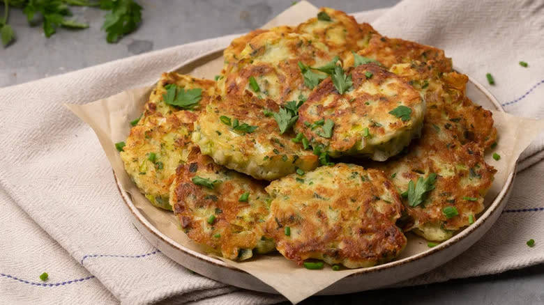 Fritters garnished with herbs on plate 