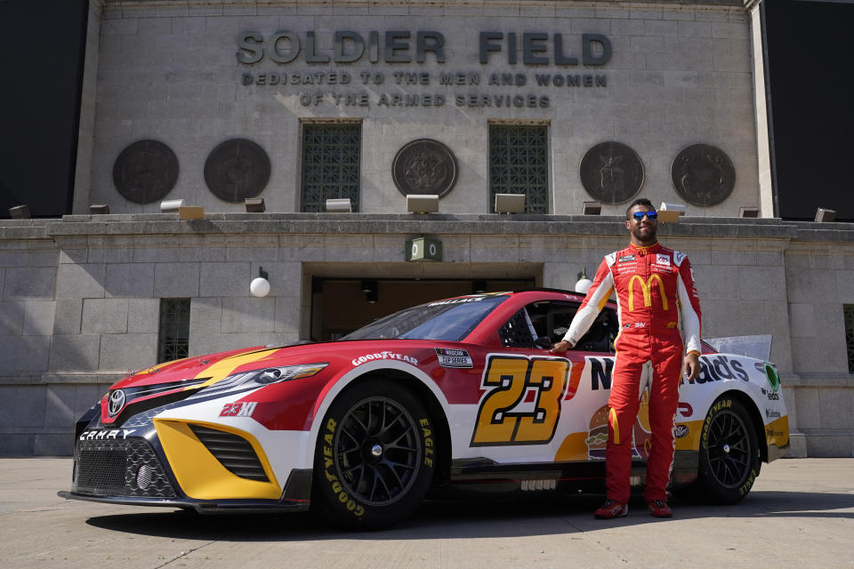 NASCAR driver Bubba Wallace poses for photos outside Soldier Field on Tuesday, July 19, 2022, in Chicago during a promotional visit to announce a Cup Series street race in the city, to be held July 2, 2023. (AP Photo/Charles Rex Arbogast)