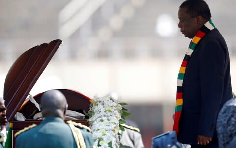 Zimbabwean president Emmerson Mnangagwa pays his last respects to Robert Mugabe - Credit: SIPHIWE SIBEKO/Reuters