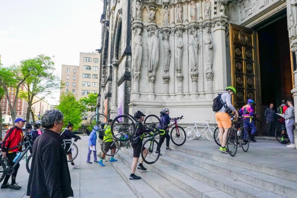 Cyclists hauled their bikes up the steps to the Cathedral of St. John the Divine Saturday morning to get their blessings. Robert Miller
