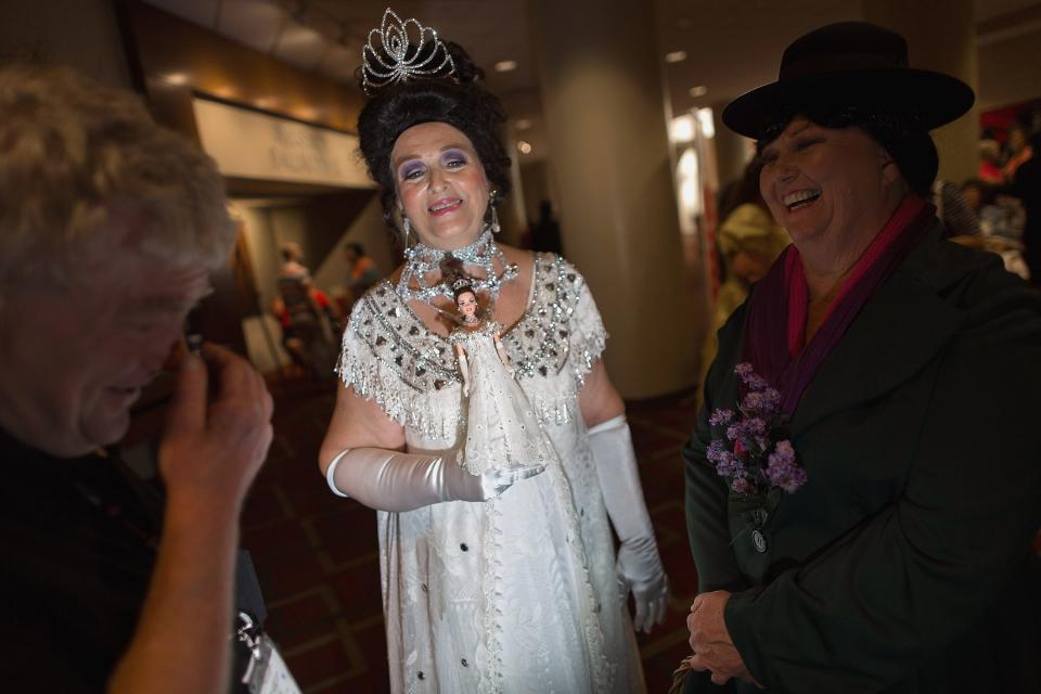 Joan Baumer of Fort Worth, TX, holds her Barbie doll as they wear matching Eliza Doolittle Embassy Ball gowns for the 2015 National Barbie Doll Collectors Convention fashion show at the Hyatt Regency Crystal City hotel July 31, 2015 in Arlington, Virginia.  Now in its 35th year, the convention draws hundreds of collectors and fans from around the world for a week-long celebration of Barbie and the cultural phenomena that surrounds the famous fashion doll.