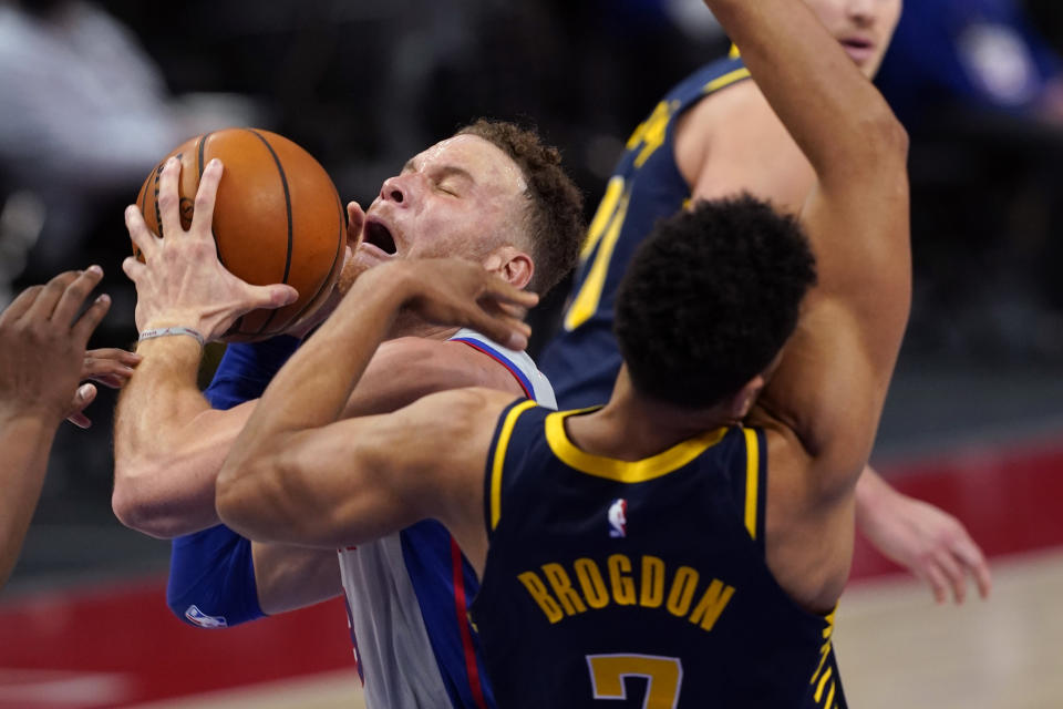 Detroit Pistons forward Blake Griffin is fouled next to Indiana Pacers guard Malcolm Brogdon (7) during the second half of an NBA basketball game, Thursday, Feb. 11, 2021, in Detroit. (AP Photo/Carlos Osorio)
