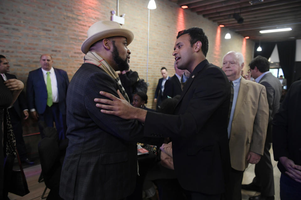 Republican Presidential candidate Vivek Ramaswamy right, meets south side residents during a town hall meeting Friday, May 19, 2023, in Chicago. (AP Photo/Paul Beaty)