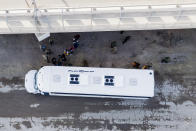 Migrants, many from Haiti, are loaded onto a bus near an encampment along the Del Rio International Bridge, Wednesday, Sept. 22, 2021, in Del Rio, Texas. (AP Photo/Julio Cortez)