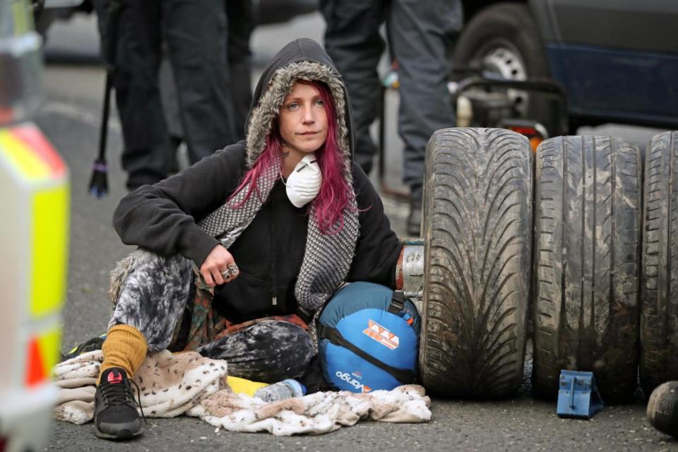 A police team cut a woman out of a set of tyres, which she had apparently cemented her arms into outside Cuadrilla's site in Preston New Road, Little Plumpton. (PA Wire/PA Images)