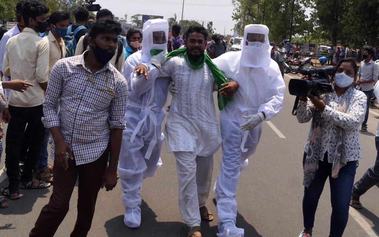 olice personals wear PPE kit as they arresting protesters in front of the state assembly house as they are arrived for protest