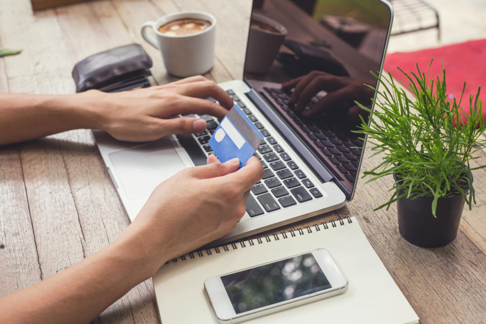 Man holding credit card and using laptop. Online shopping