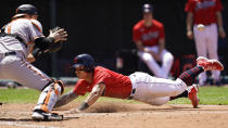 Cleveland Indians' Yu Chang, right, slides safely into home plate as Baltimore Orioles' Austin Wynns waits of the ball in the fourth inning of a baseball game, Thursday, June 17, 2021, in Cleveland. (AP Photo/Tony Dejak)