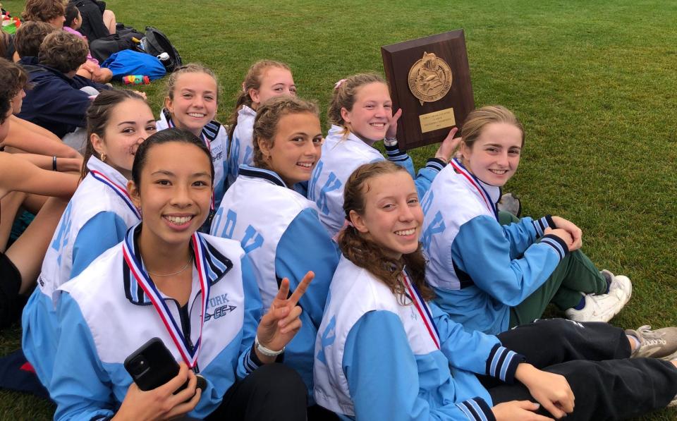 Members of the York High School girls cross country team celebrate after winning Saturday's Class B Southern Regional championship at Twin Brook Recreation Area in Cumberland, Maine.