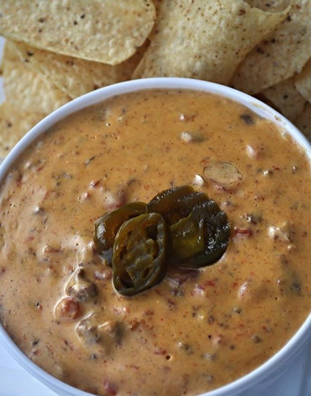 <p>Krista Marshall</p><p>Ground beef, taco seasoning, Velveeta and pickled jalapeños come together in a creamy dip you will want to make a double batch of.</p><p><strong>Get the recipe: <a href="https://parade.com/842255/kristamarshall/crock-pot-spicy-beef-queso/" rel="nofollow noopener" target="_blank" data-ylk="slk:Crock Pot Spicy Beef Queso;elm:context_link;itc:0;sec:content-canvas" class="link ">Crock Pot Spicy Beef Queso</a></strong></p>