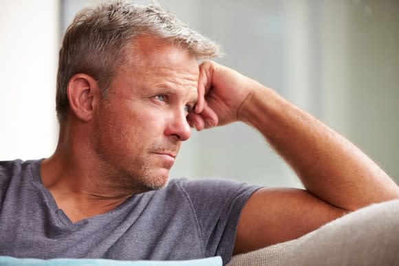 Man staring off into the distance looking worried