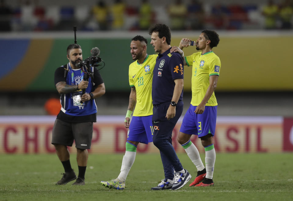 Brazil's Neymar, center, and Brazil's coach Fernando Diniz leave the pitch after a qualifying soccer match for the FIFA World Cup 2026 against Bolivia at Mangueirao stadium in Belem, Brazil, Friday, Sept. 8, 2023. Brazil won 5-1. (AP Photo/Bruna Prado)