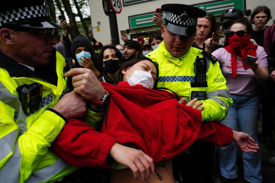 Woman carried by police outside hotel in Peckham (Getty Images)