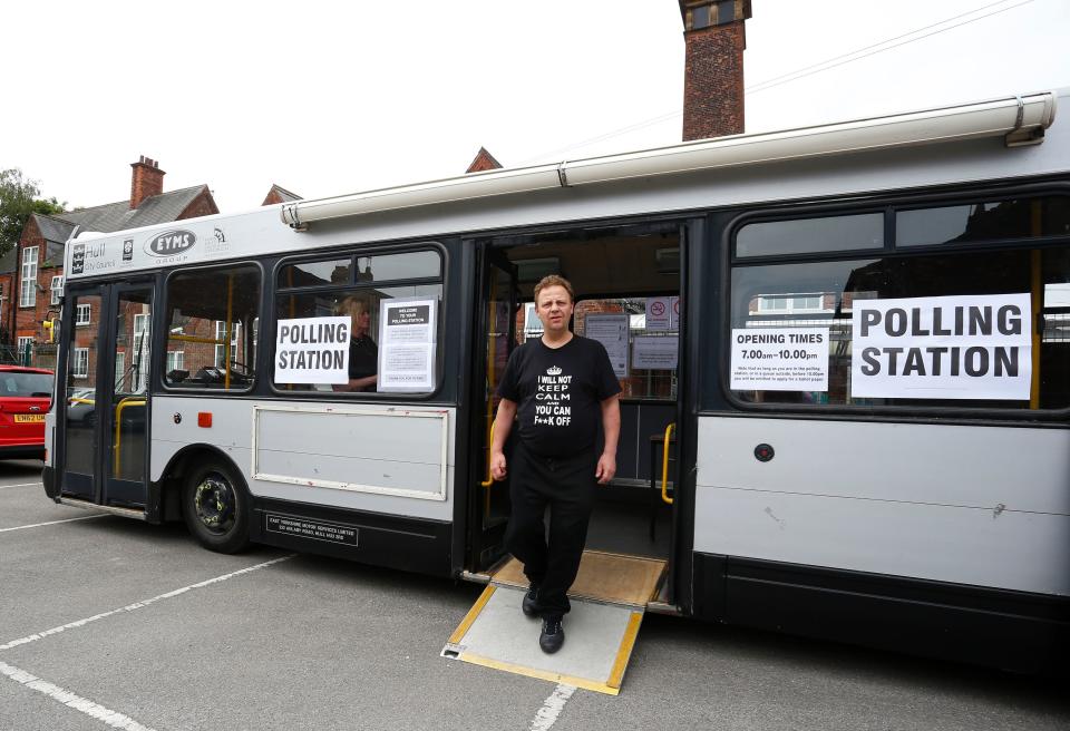 A local resident leaves after casting his vote in a bus being used as a temporary polling station in Kingston-Upon-Hull, northern England on June 23, 2016.&nbsp;