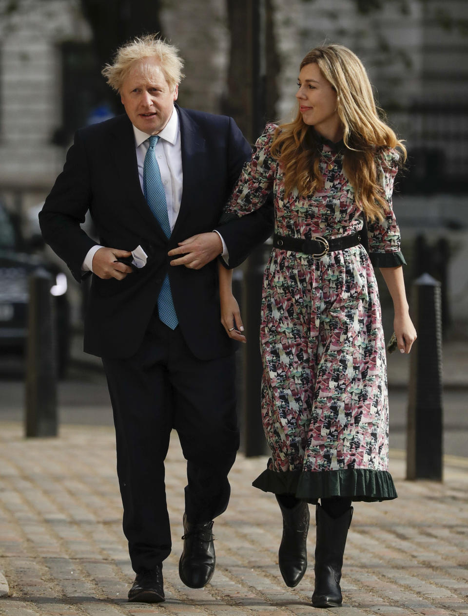 FILE - In this Thursday May 6, 2021, file photo, British Prime Minister Boris Johnson arrives at a polling station with his partner Carrie Symonds to cast his vote in local council elections in London. U.K. newspapers are reporting that Prime Minister Johnson and his fiancée Symonds married Saturday, May 29, 2021, in a small private ceremony in London. The Mail on Sunday and the Sun said the couple wed at the Roman Catholic Westminster Cathedral in front of a small group of friends and family. (AP Photo/Matt Dunham, File)