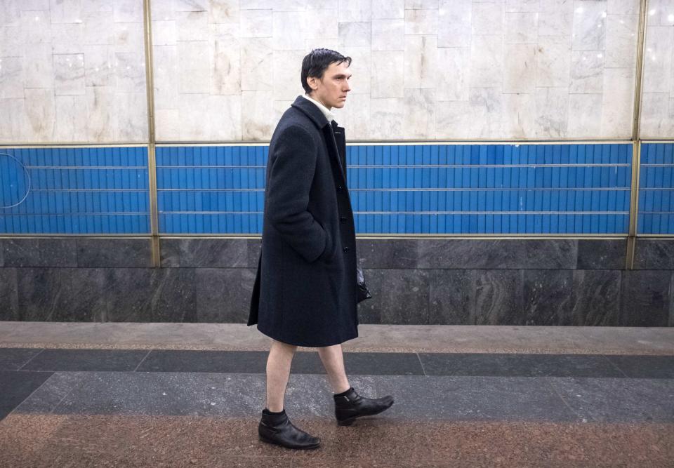 A passenger without pants waits on an underground platform during the "No Pants Subway Ride" in Kiev